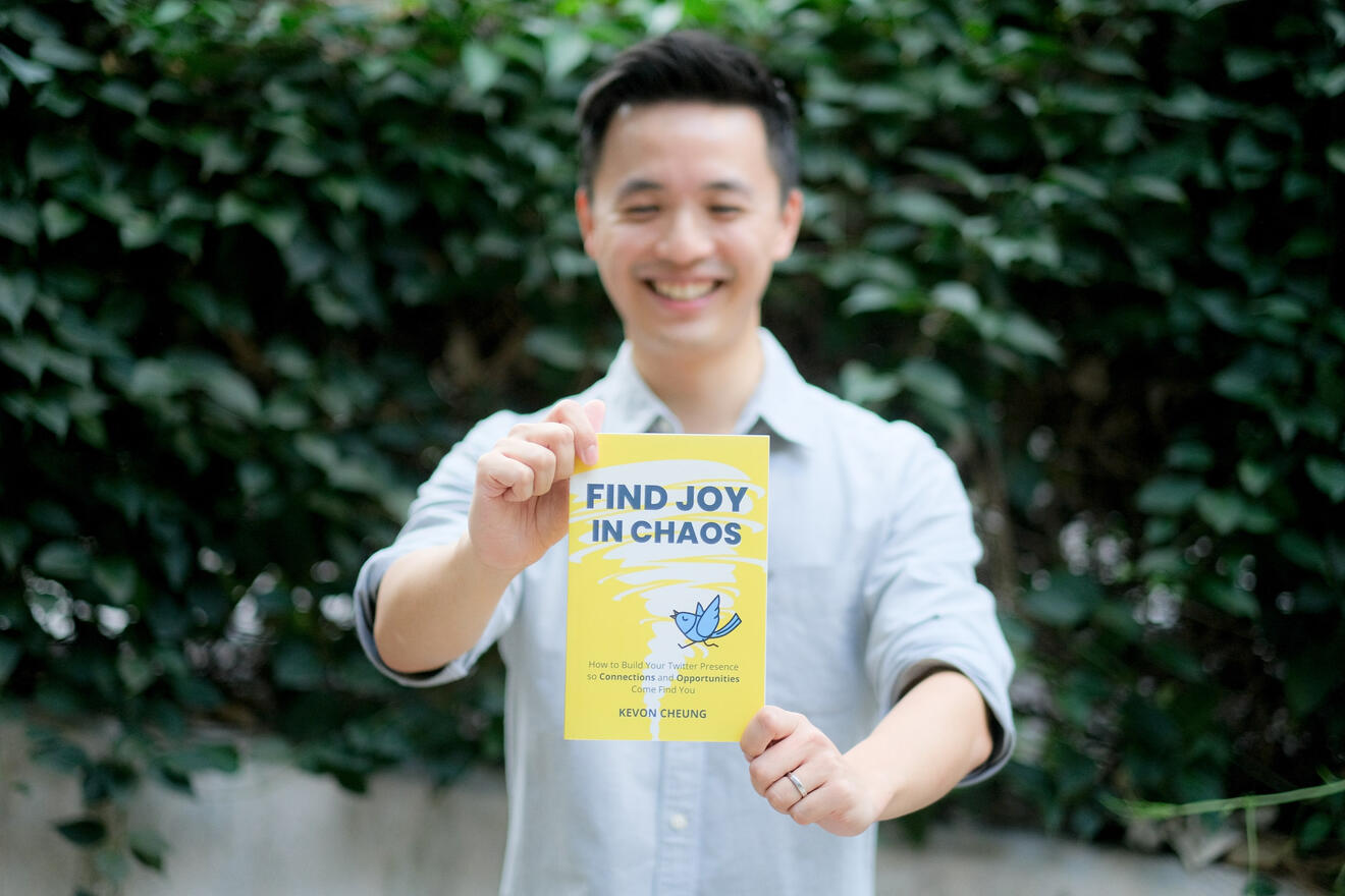 Kevon Cheung holding Find Joy in Chaos